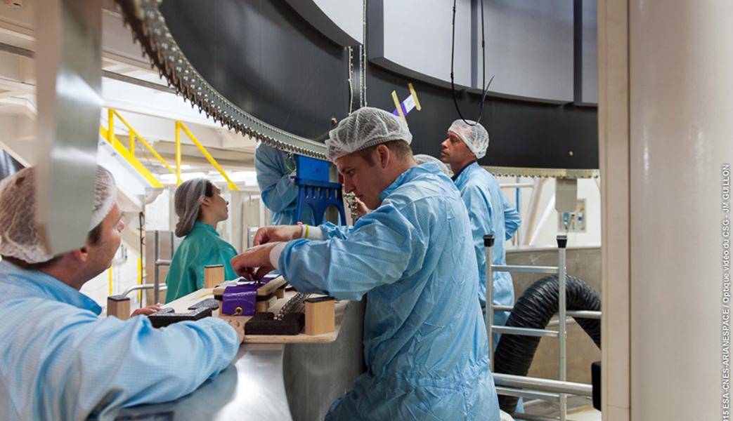 Employees are working on part of a rocket in the factory