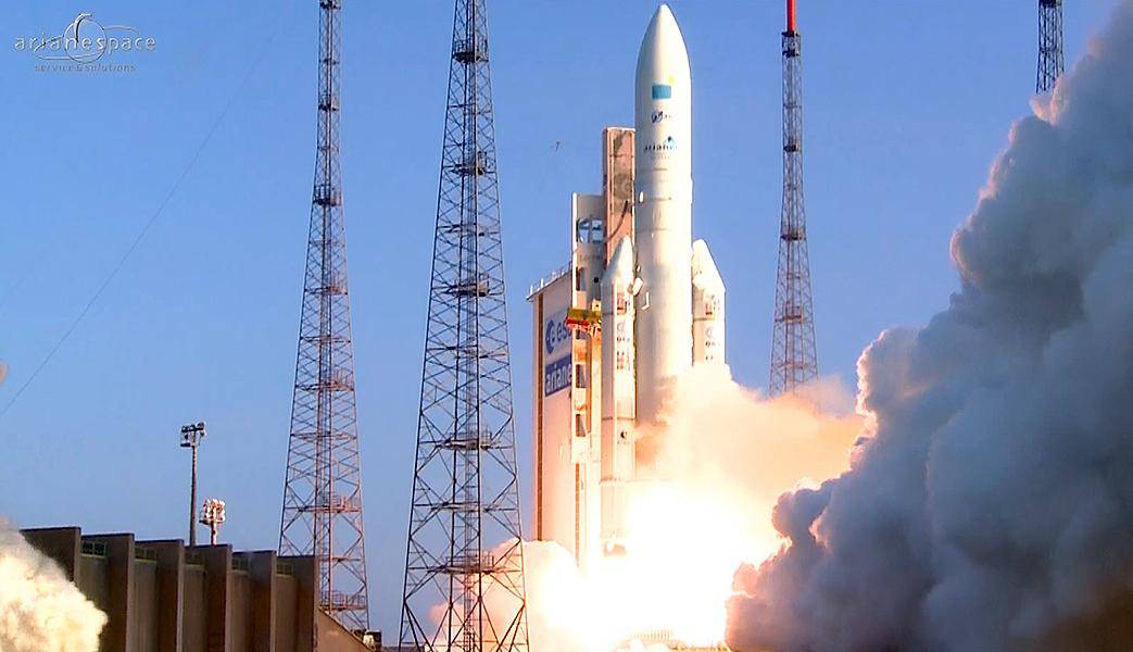 A rocket is starting to take off from its launchpad with plumes of flames and smoke coming from the engines