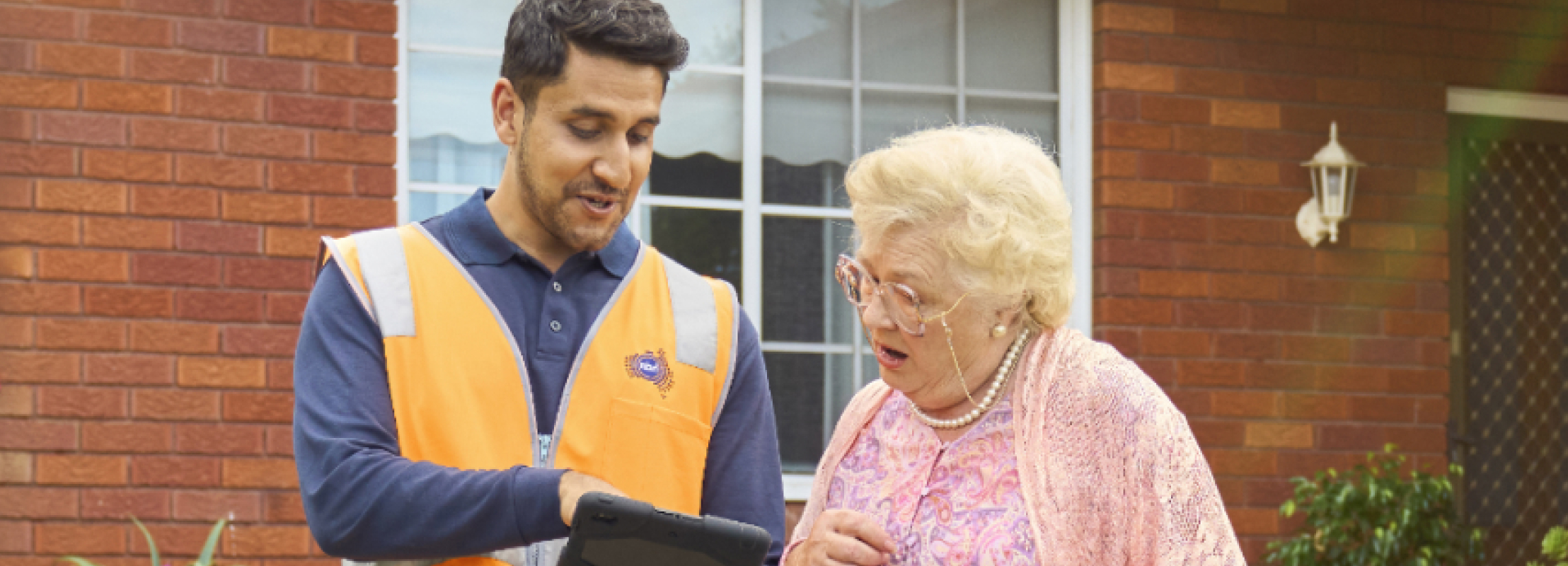 Man and lady looking at tablet